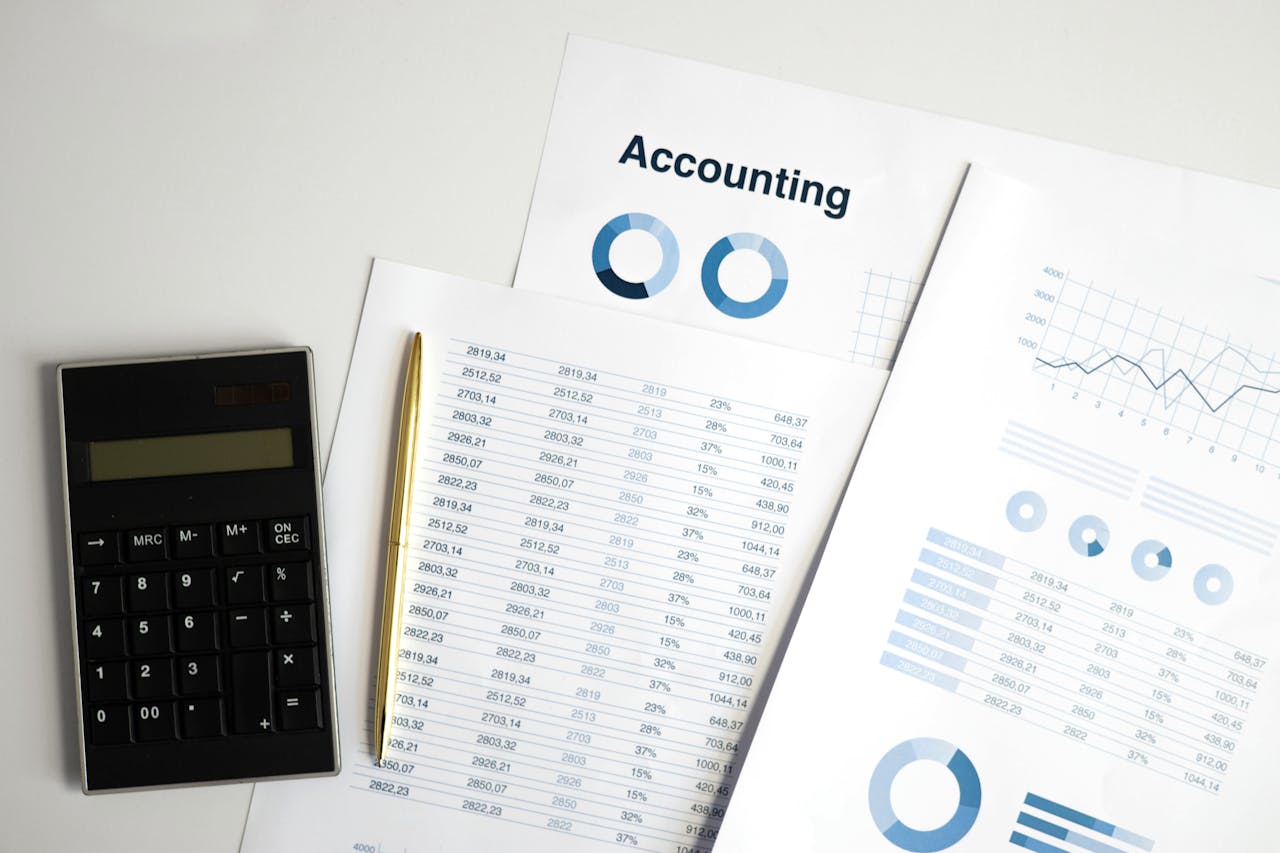 Services Calculator and accounting documents with charts on a workspace.