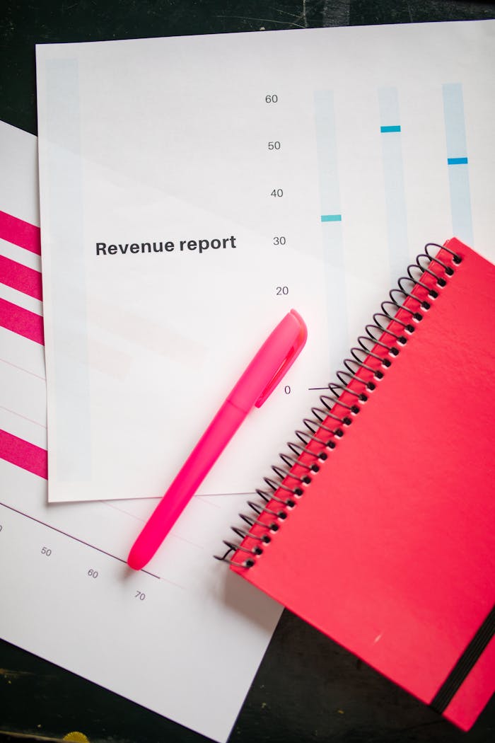 Services Revenue report with a pink notebook and pen on a bright flatlay, perfect for business presentations.